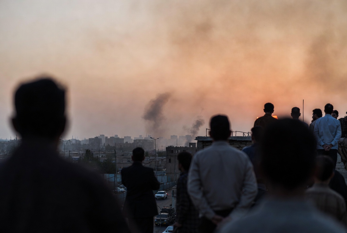Illustrative image of Tehran at sunset amid the fragile 2026 West Asia truce, with smoke visible on the horizon