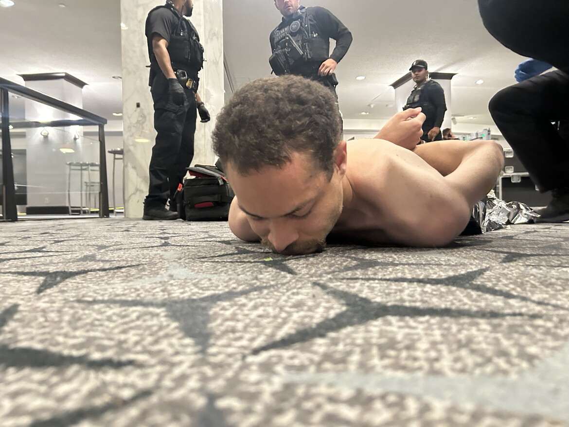 Cole Tomas Allen, the 31-year-old suspect from Torrance, California, lying shirtless and handcuffed on the carpet after being tackled by law enforcement during the shooting incident at the Washington Hilton hotel while President Trump attended the White House Correspondents’ Association Dinner on 25 April 2026.