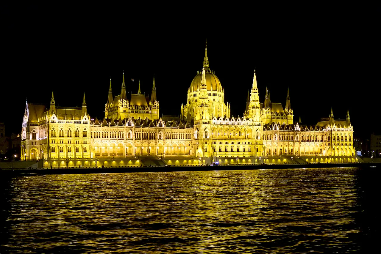 Illuminated Hungarian Parliament Building at night with dramatic reflections in the Danube River, Budapest, Hungary.