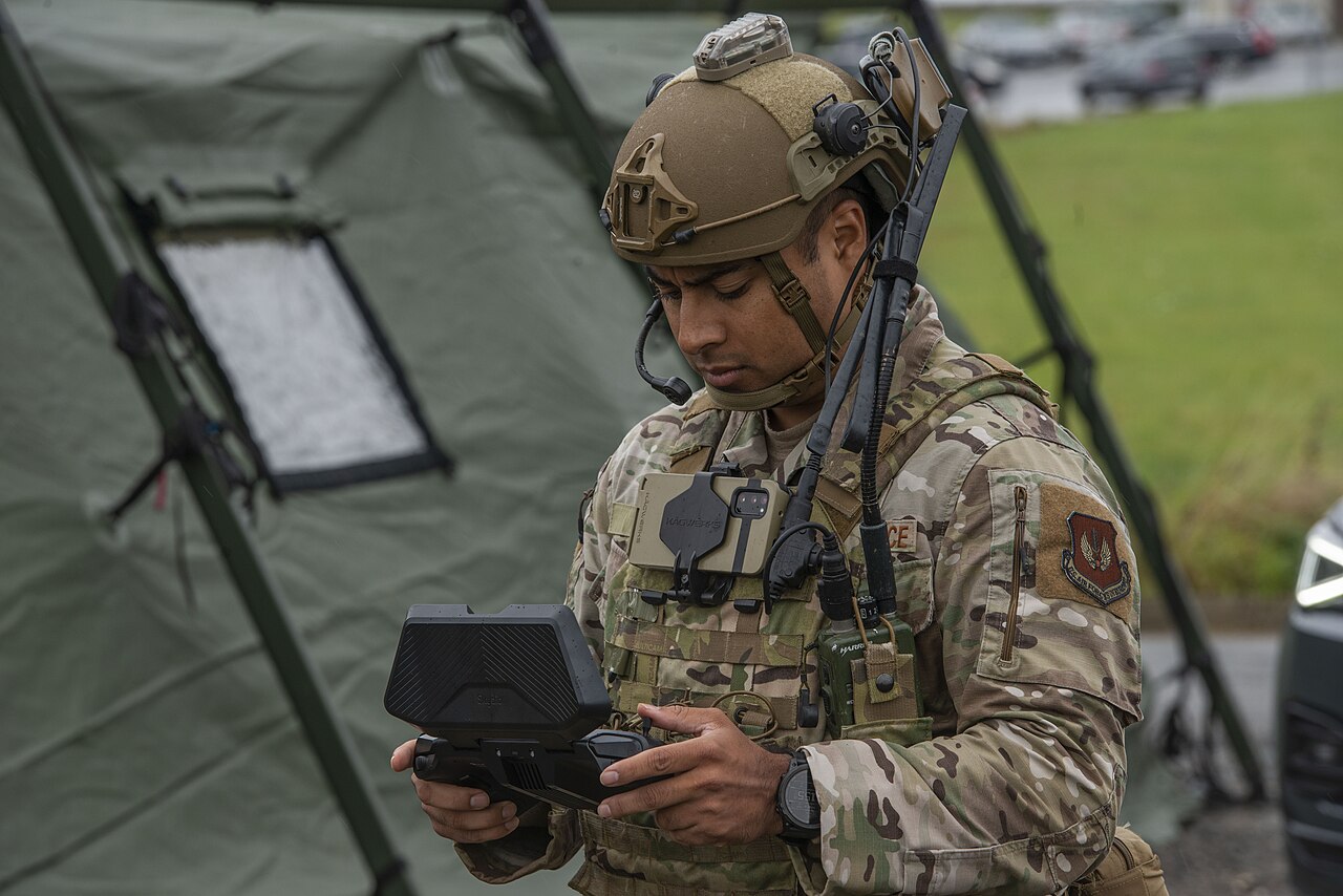 U.S. Air Force Staff Sgt. Daniel Ubau operates a small unmanned aircraft system (sUAS) during AI-integrated military training with a robodog at the Polygone Training Compound in Germany.