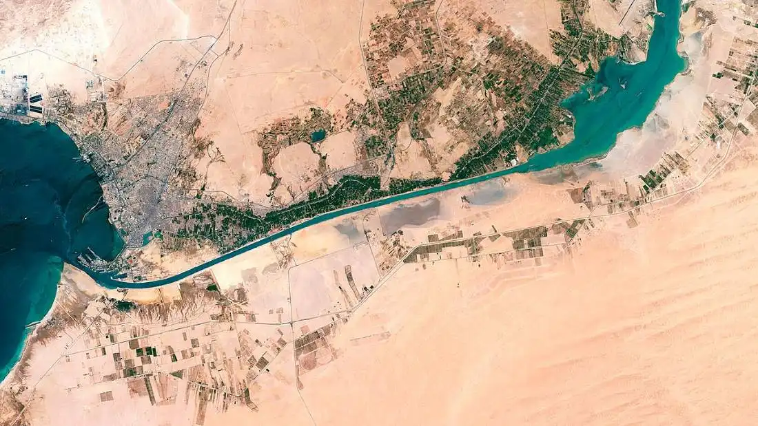 Satellite view of the Suez Canal in Egypt, a critical economic lifeline now threatened by regional conflict and Red Sea disruptions.