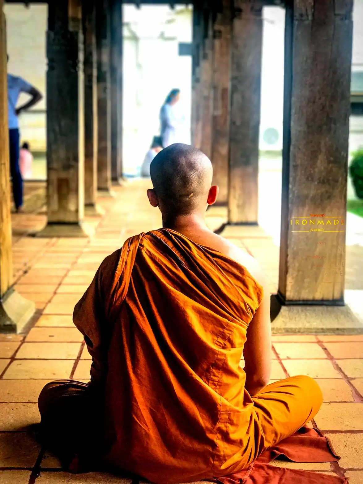 A monk calmly mediating amid all distractions around